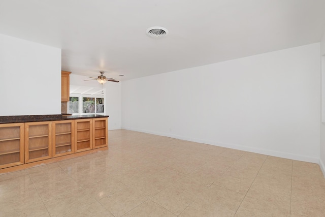 living room featuring ceiling fan, visible vents, and baseboards