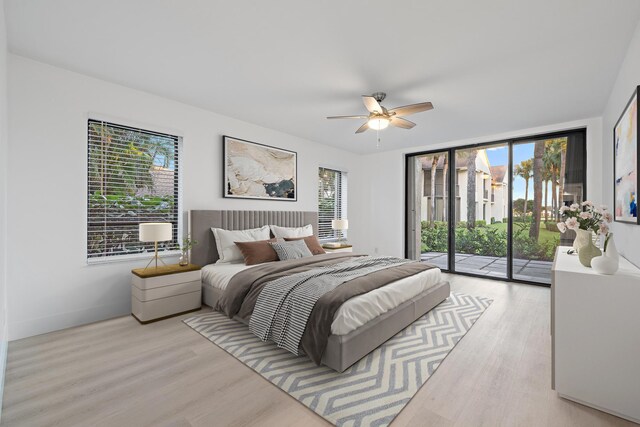 bedroom with multiple windows, ceiling fan, and access to exterior