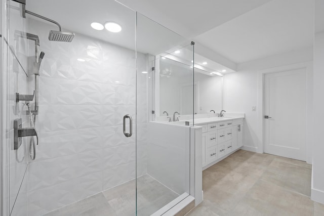 full bathroom featuring double vanity, a stall shower, a sink, and visible vents