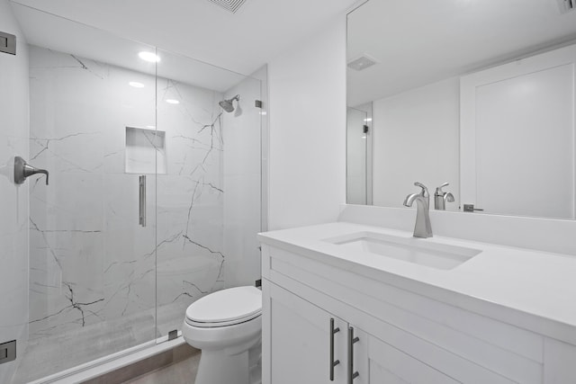 full bathroom featuring visible vents, vanity, a marble finish shower, and toilet