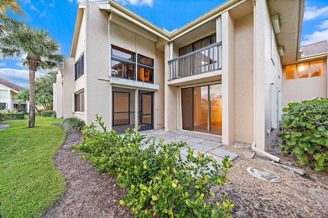 rear view of property with a yard