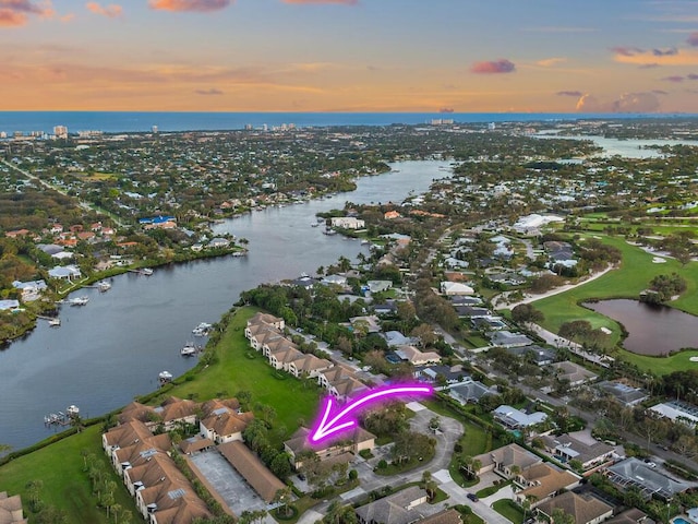 aerial view at dusk with a water view