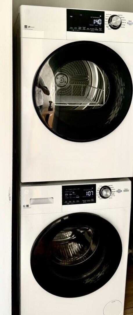 clothes washing area with stacked washer / drying machine