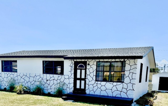 view of front facade with a storage unit