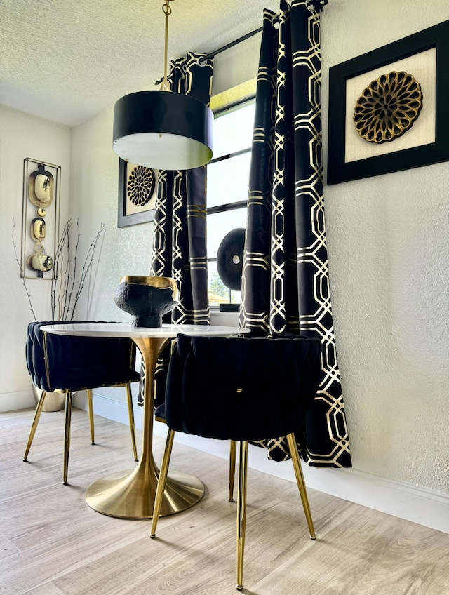 miscellaneous room with a textured ceiling and hardwood / wood-style flooring