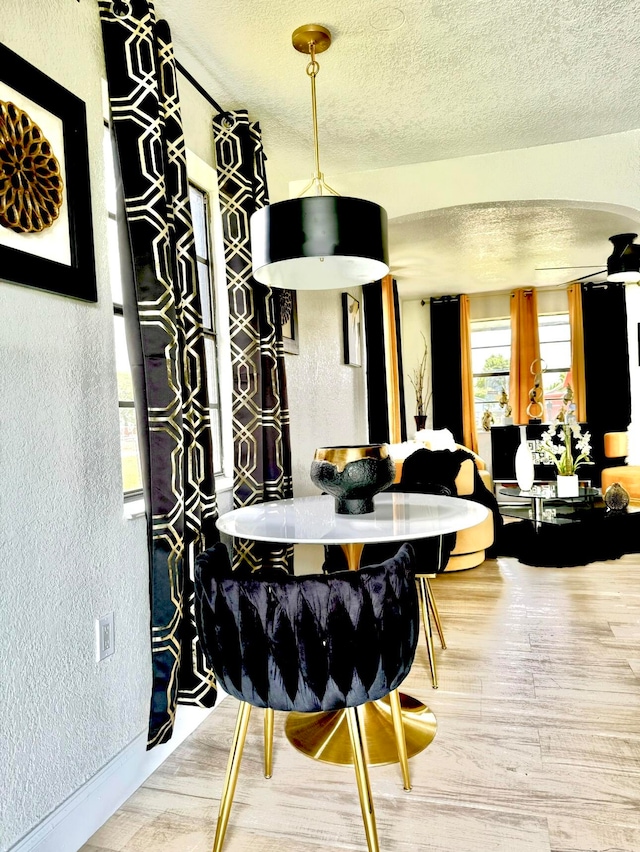 dining room featuring hardwood / wood-style flooring and a textured ceiling