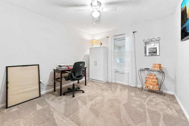 carpeted office space featuring a textured ceiling and ceiling fan