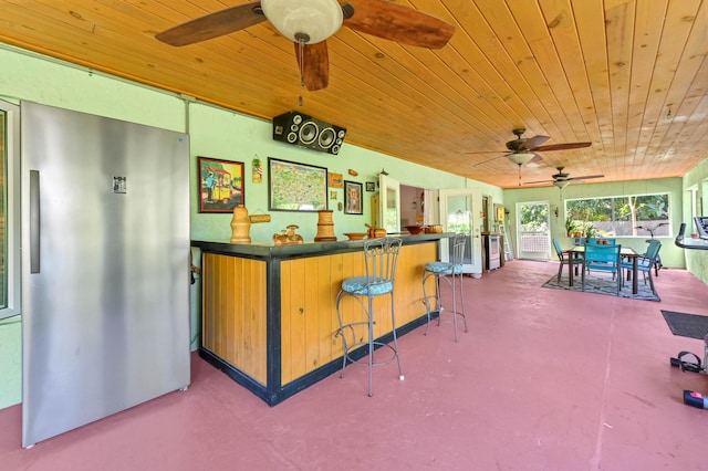 view of patio / terrace with ceiling fan and an outdoor bar