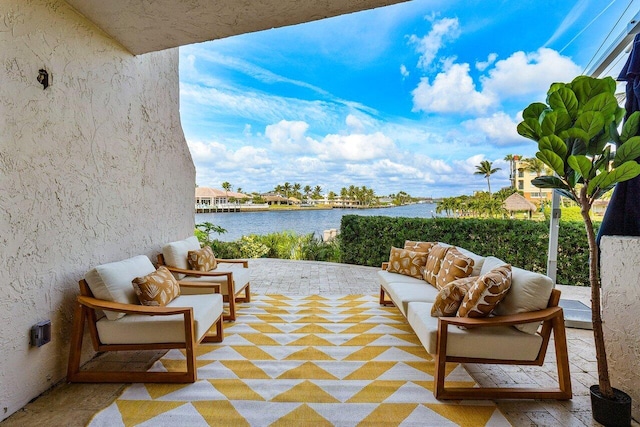 view of patio / terrace with outdoor lounge area and a water view