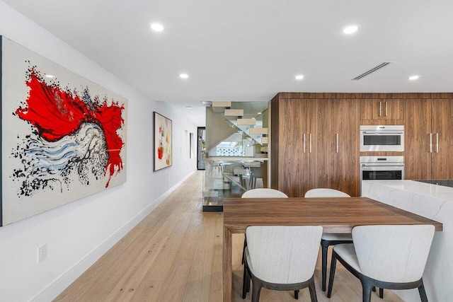 dining space featuring light wood-type flooring