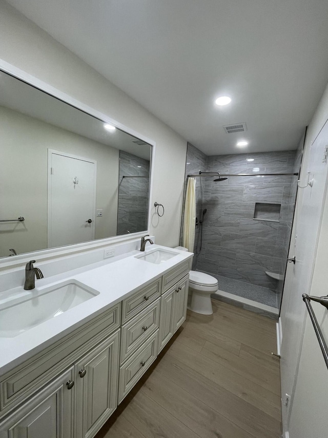 670 Monaco N Unit N, Delray Beach, FL 33446 - full bath featuring toilet, tiled shower, double vanity, wood finished floors, and recessed lighting