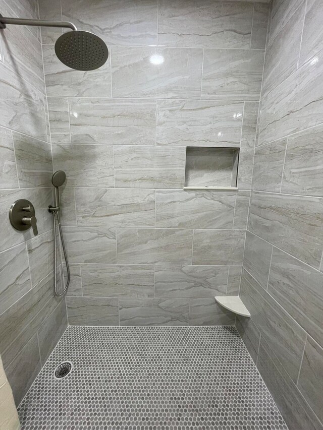 bathroom with tiled shower