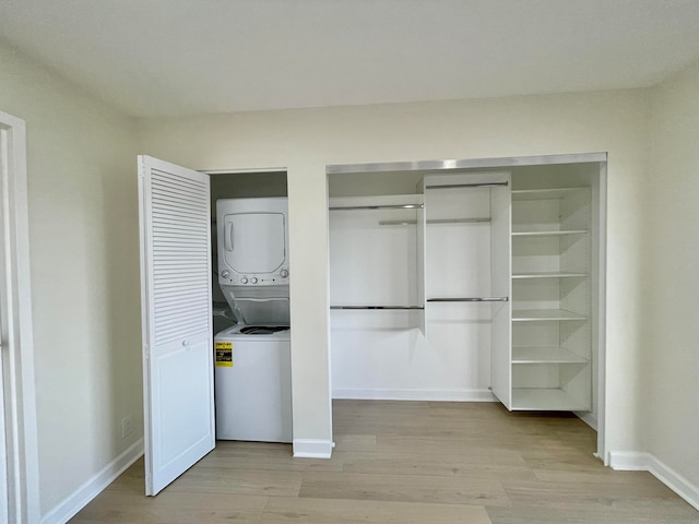 closet featuring stacked washer / dryer