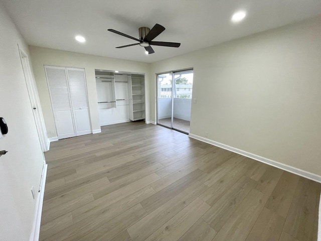 670 Monaco N Unit N, Delray Beach, FL 33446 - unfurnished bedroom featuring wood finished floors, baseboards, recessed lighting, a ceiling fan, and multiple closets
