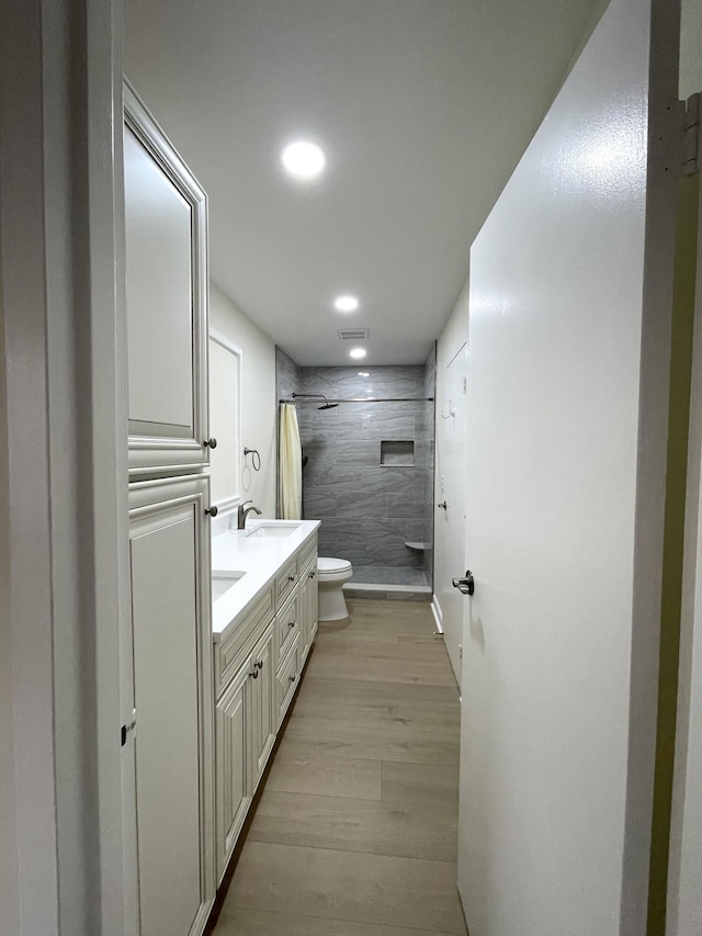 670 Monaco N Unit N, Delray Beach, FL 33446 - full bath with toilet, a shower stall, wood finished floors, double vanity, and recessed lighting