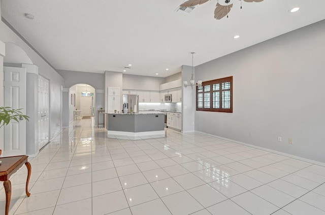 unfurnished living room with ceiling fan and light tile patterned flooring