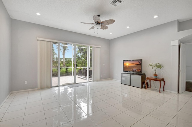 unfurnished living room with light tile patterned floors, a textured ceiling, and ceiling fan