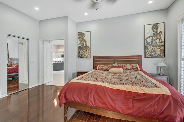 bedroom with hardwood / wood-style floors, ceiling fan, and a closet