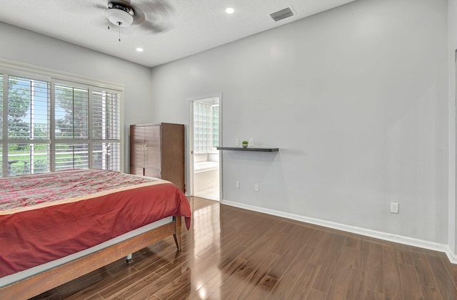 bedroom featuring ceiling fan, dark hardwood / wood-style floors, a textured ceiling, and ensuite bath