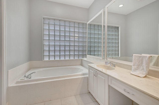 bathroom featuring vanity, tiled bath, and tile patterned floors