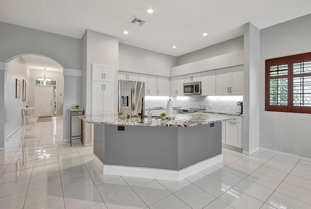 kitchen featuring white cabinetry, a kitchen island with sink, and appliances with stainless steel finishes