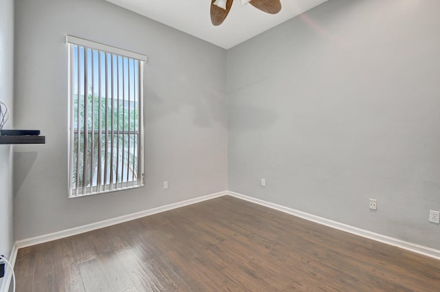 spare room with ceiling fan and dark hardwood / wood-style flooring