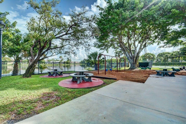 exterior space with a water view and a playground