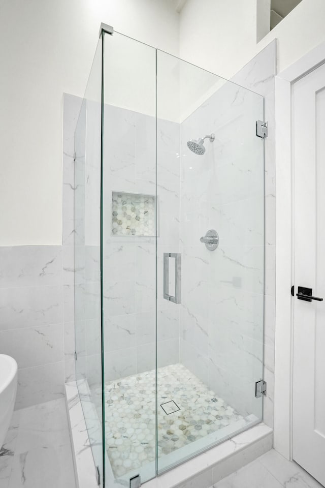 bathroom with a shower with door