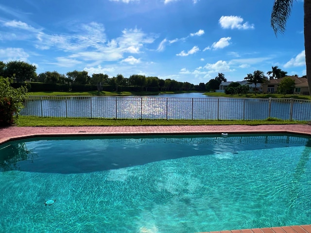 view of pool with a water view