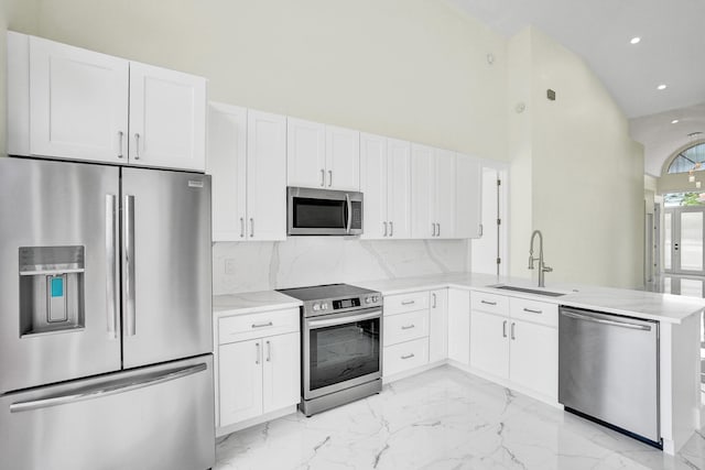 kitchen with white cabinetry, kitchen peninsula, sink, and appliances with stainless steel finishes