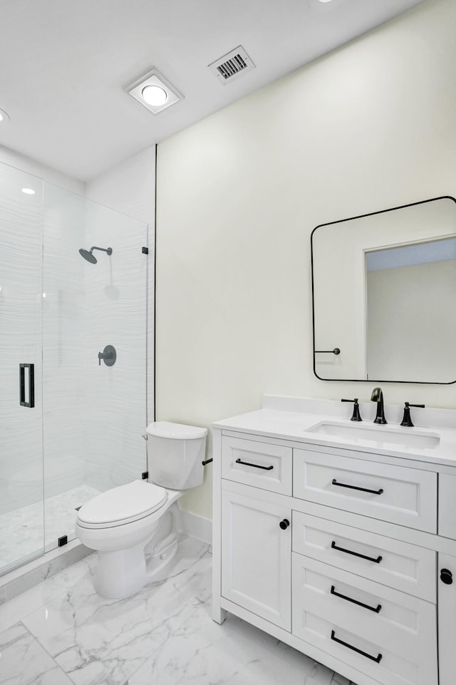 bathroom featuring vanity, toilet, and a shower with door