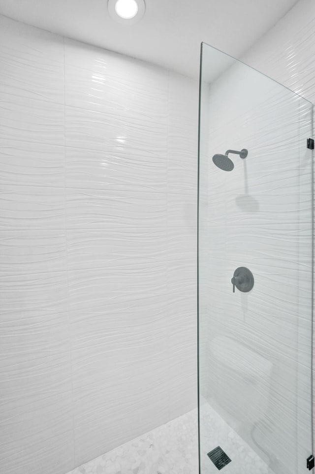 bathroom with a tile shower