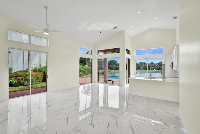 interior space with ceiling fan, a water view, and high vaulted ceiling