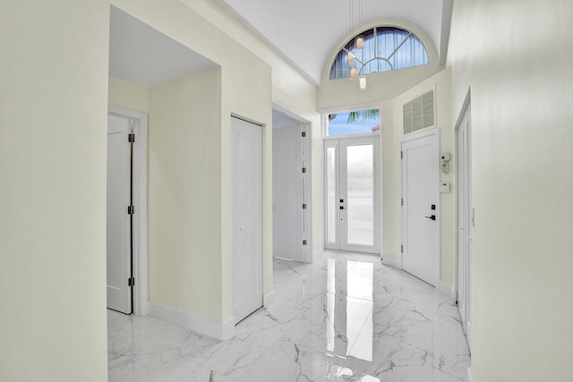 entrance foyer with high vaulted ceiling