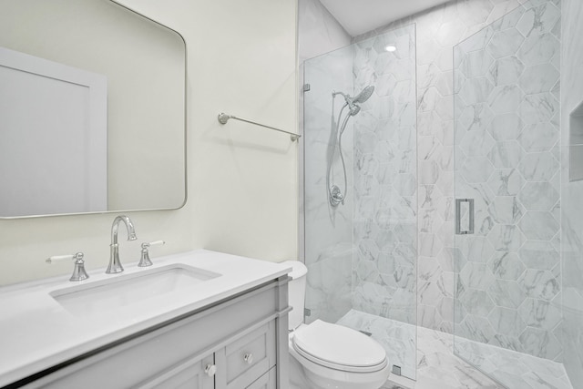 bathroom with vanity, a shower with shower door, and toilet