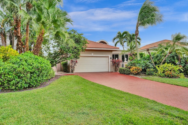 view of front of home with a garage and a front yard