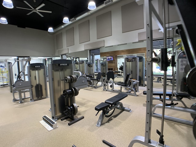 17264 Hampton Blvd, Boca Raton, FL 33496 - workout area with a towering ceiling and wood walls