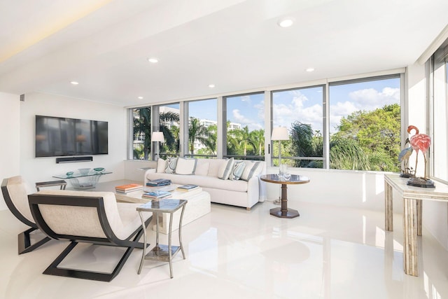 living room with light tile patterned floors and floor to ceiling windows