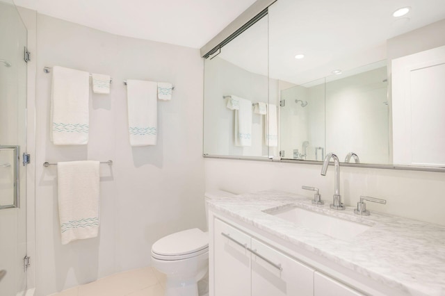 bathroom featuring walk in shower, tile patterned flooring, vanity, and toilet