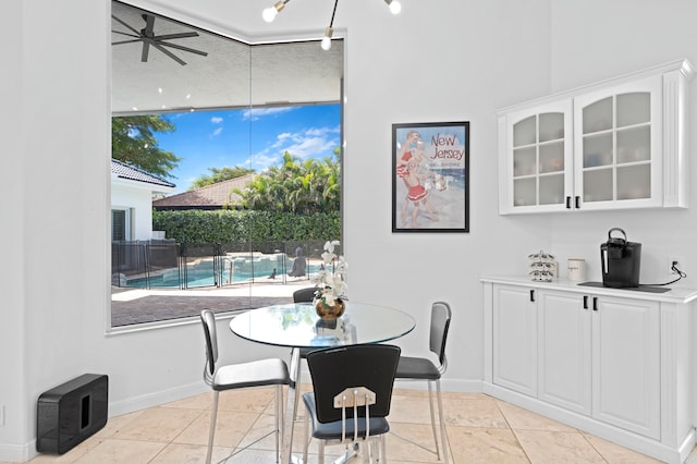 dining space featuring ceiling fan and track lighting