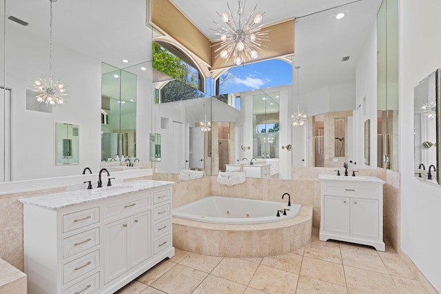 bathroom with tile patterned flooring, a notable chandelier, independent shower and bath, and vanity