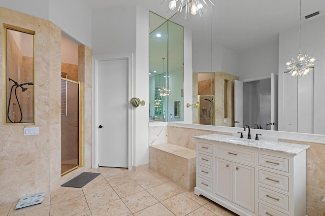 bathroom featuring tile patterned floors, a shower with door, vanity, and an inviting chandelier