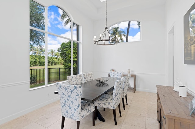 tiled dining room with a chandelier and plenty of natural light