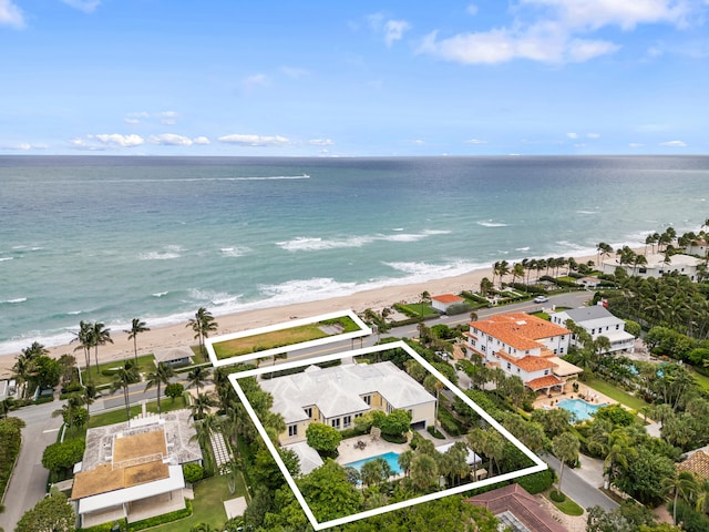 drone / aerial view with a water view and a view of the beach