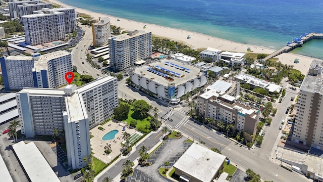 birds eye view of property with a beach view and a water view