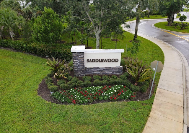 community / neighborhood sign with a lawn