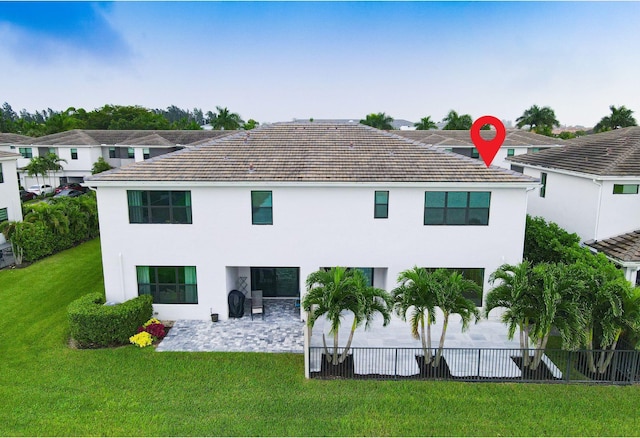 rear view of house featuring a lawn