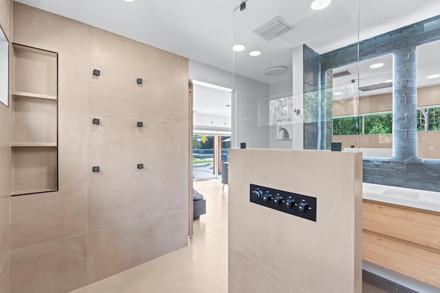 bathroom with walk in shower, vanity, tile patterned floors, and tile walls