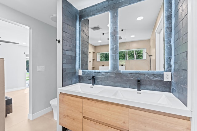 bathroom featuring toilet, vanity, and tile patterned floors