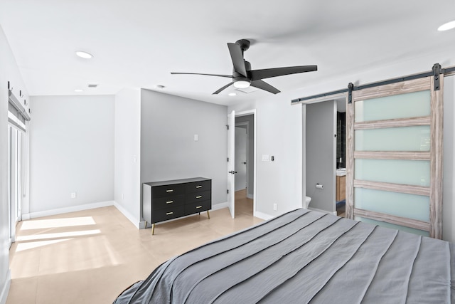 bedroom featuring a barn door and ceiling fan